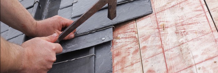 Roofer working with slate